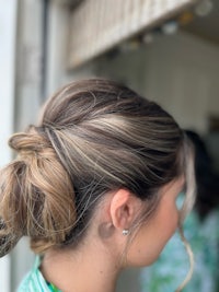 a woman with her hair up in a bun
