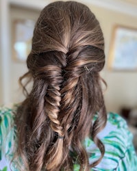 the back of a woman's hair with a fishtail braid