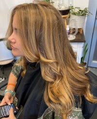 a woman is getting her hair done in a salon