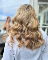 the back of a woman's hair with long wavy hair