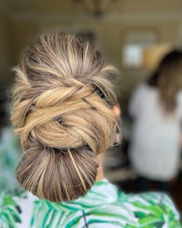 the back of a woman's hair in a braided bun